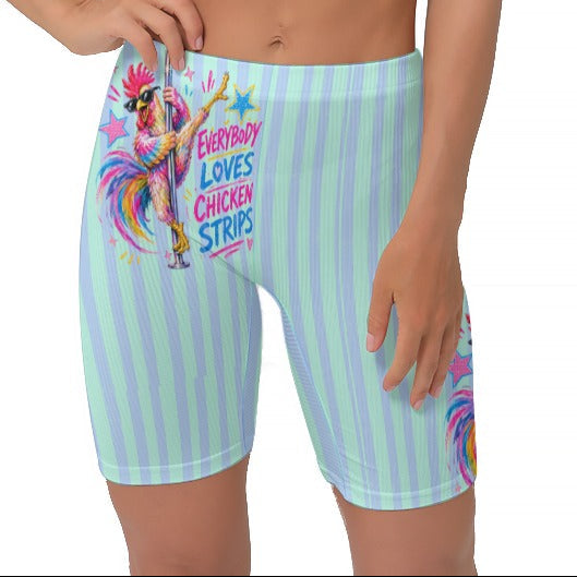 A woman modeling light blue and seafoam vertically striped biker shorts with a colourful cartoon graphic and the text 'EVERYBODY LOVES CHICKEN STRIPS'.