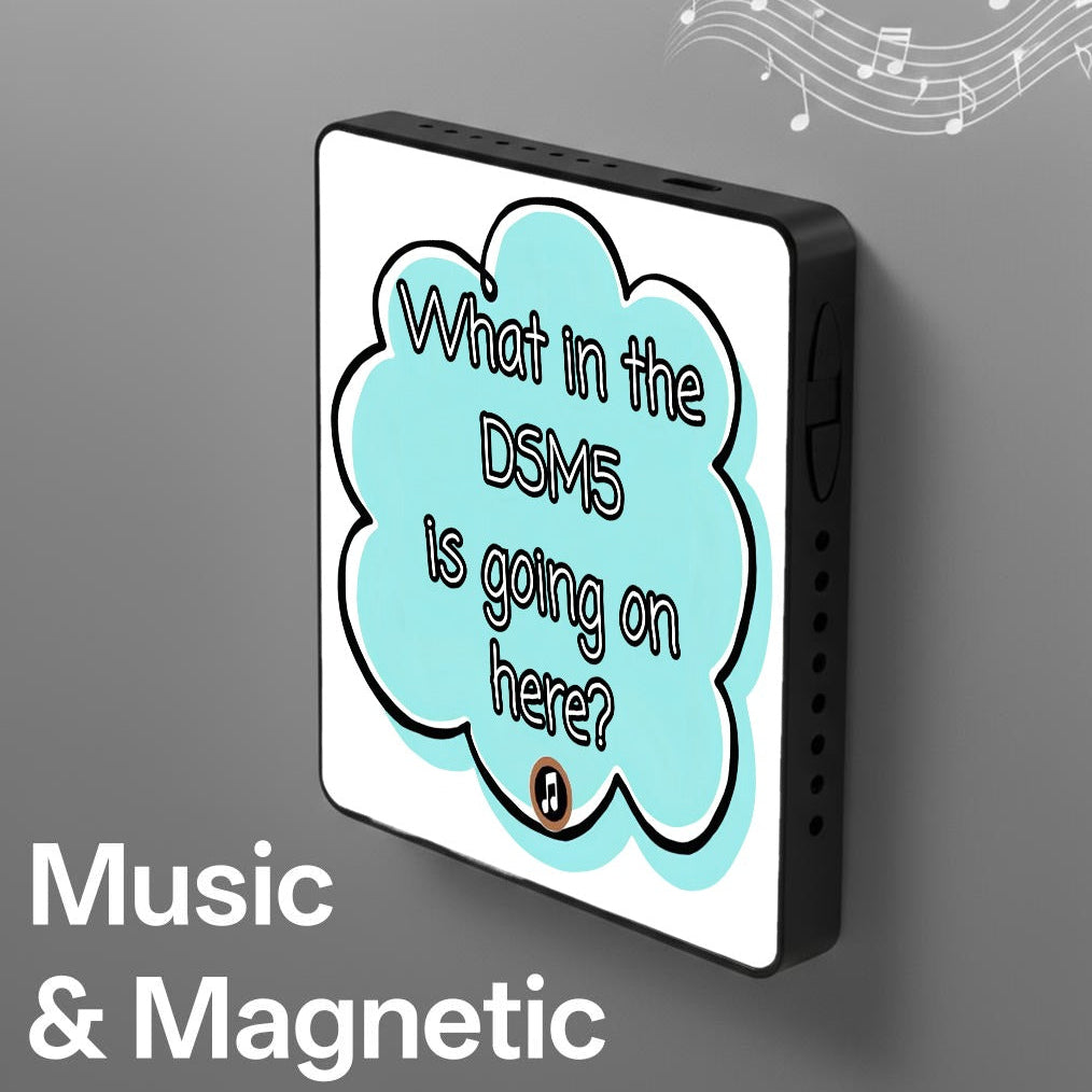 A square black electronic device with a white faceplate and a light blue speech-bubble graphic containing the text 'What in the DSM5 is going on here?'. The image includes the words 'Music & Magnetic' in white text at the bottom left and decorative music notes in the top right on a gray background.