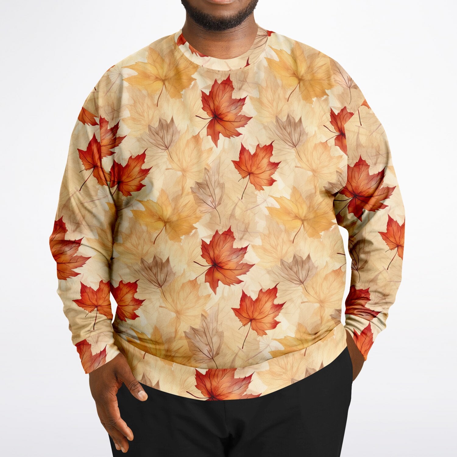 Person wearing a sweatshirt with autumn leaf pattern on a plain background