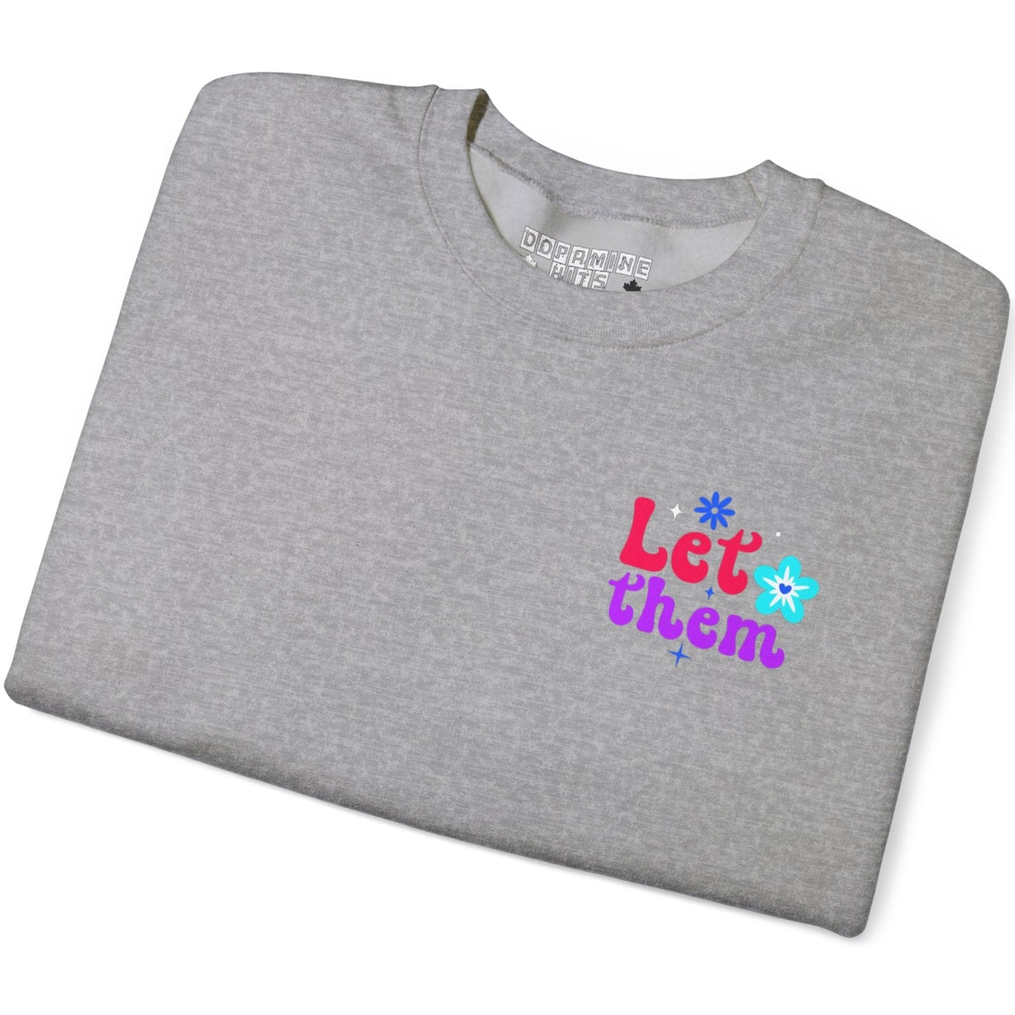 Folded gray t-shirt with colorful text and flower graphics on a white background