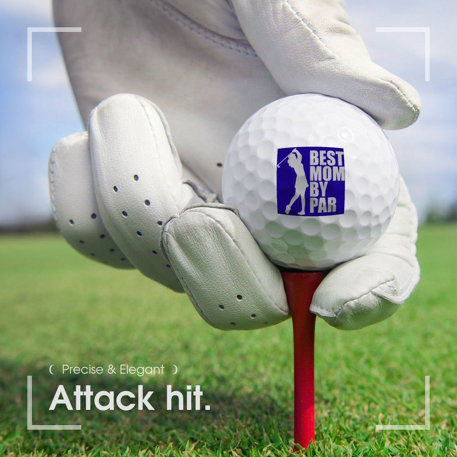 Golf ball with 'Best Mom By Par' sticker on a tee, held by a gloved hand on a golf course.