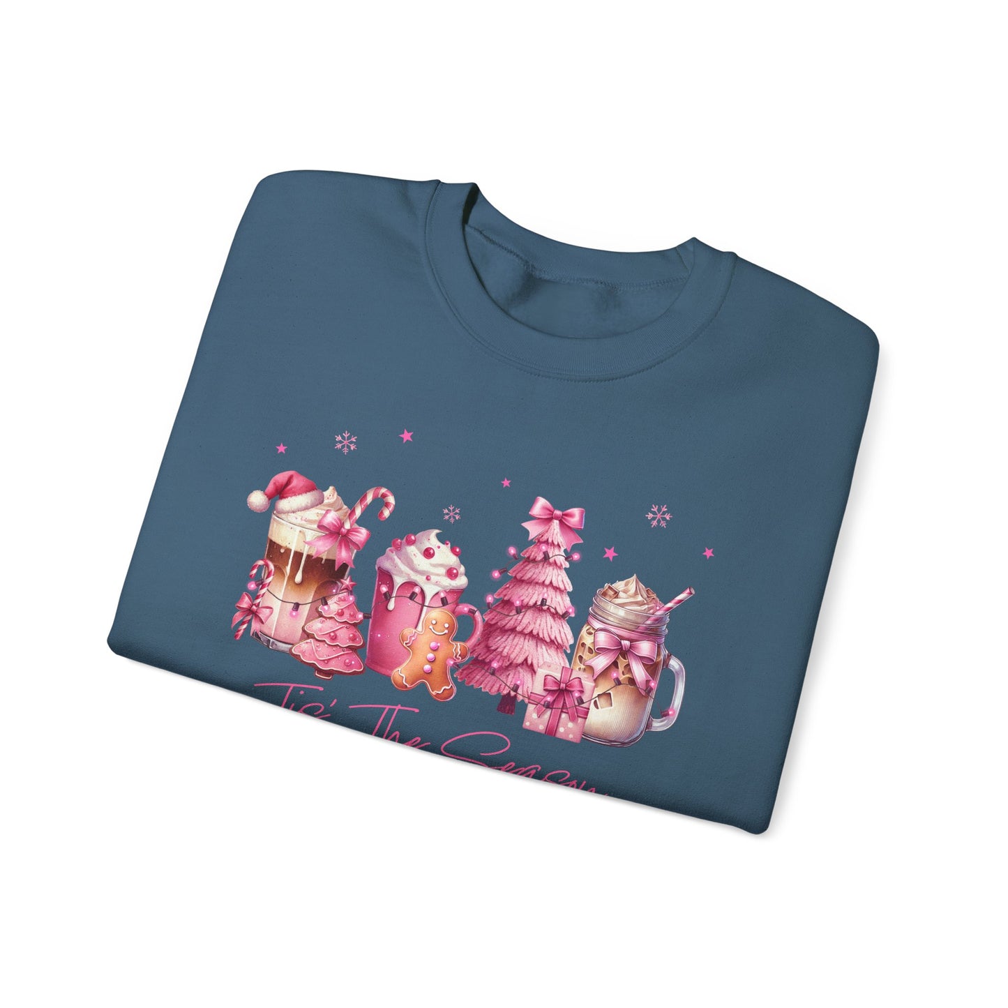 Folded blue sweatshirt with Christmas-themed design on a white background