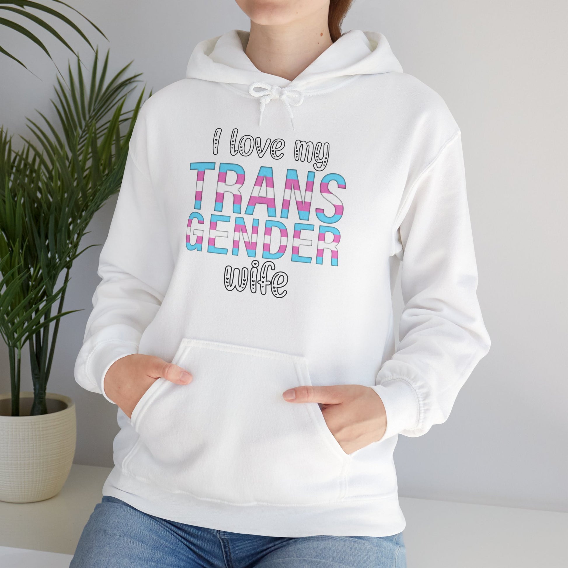 Person wearing a white hoodie with 'I love my TRANS GENDER wife' text.