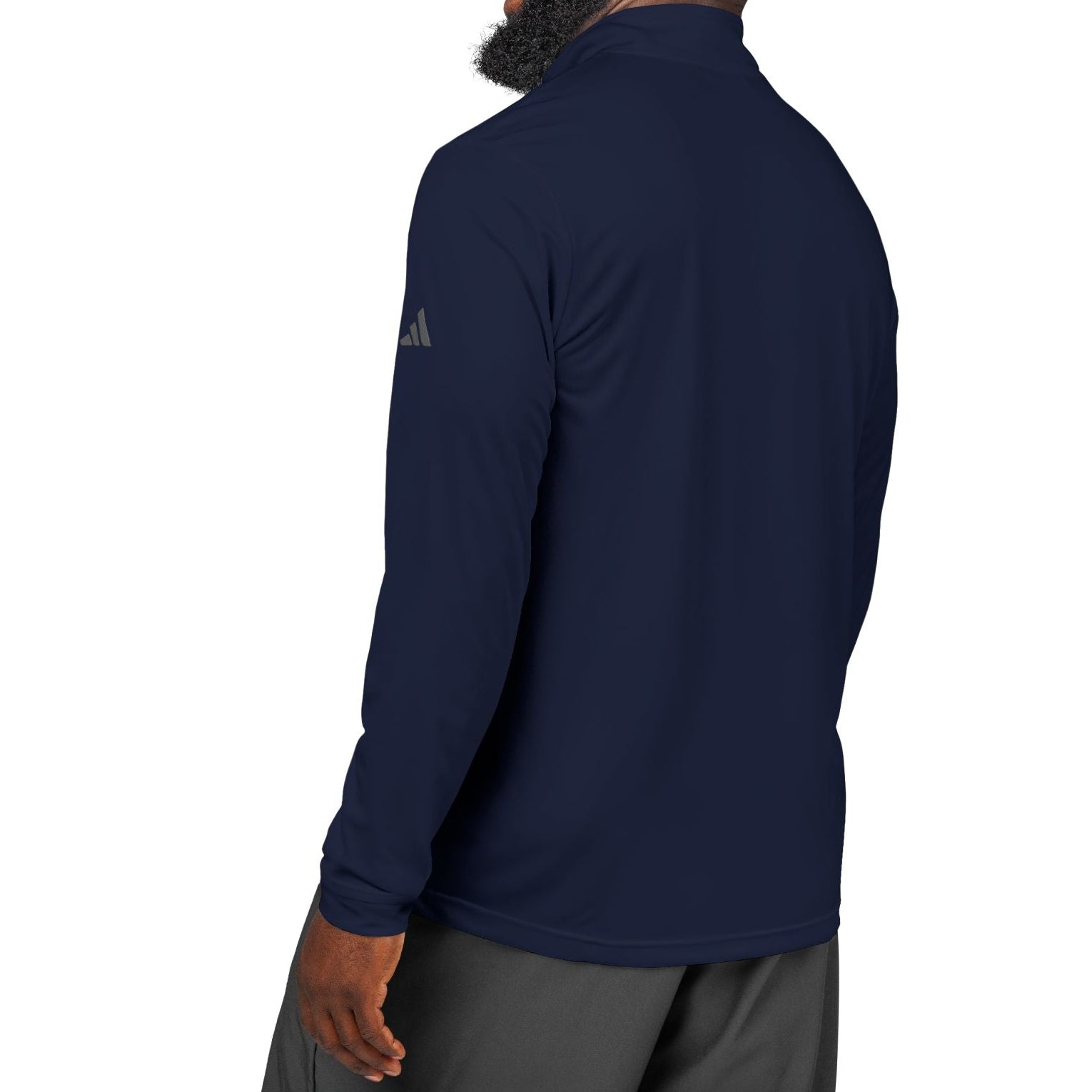 Man wearing a navy long-sleeve shirt with Adidas logo on a white background
