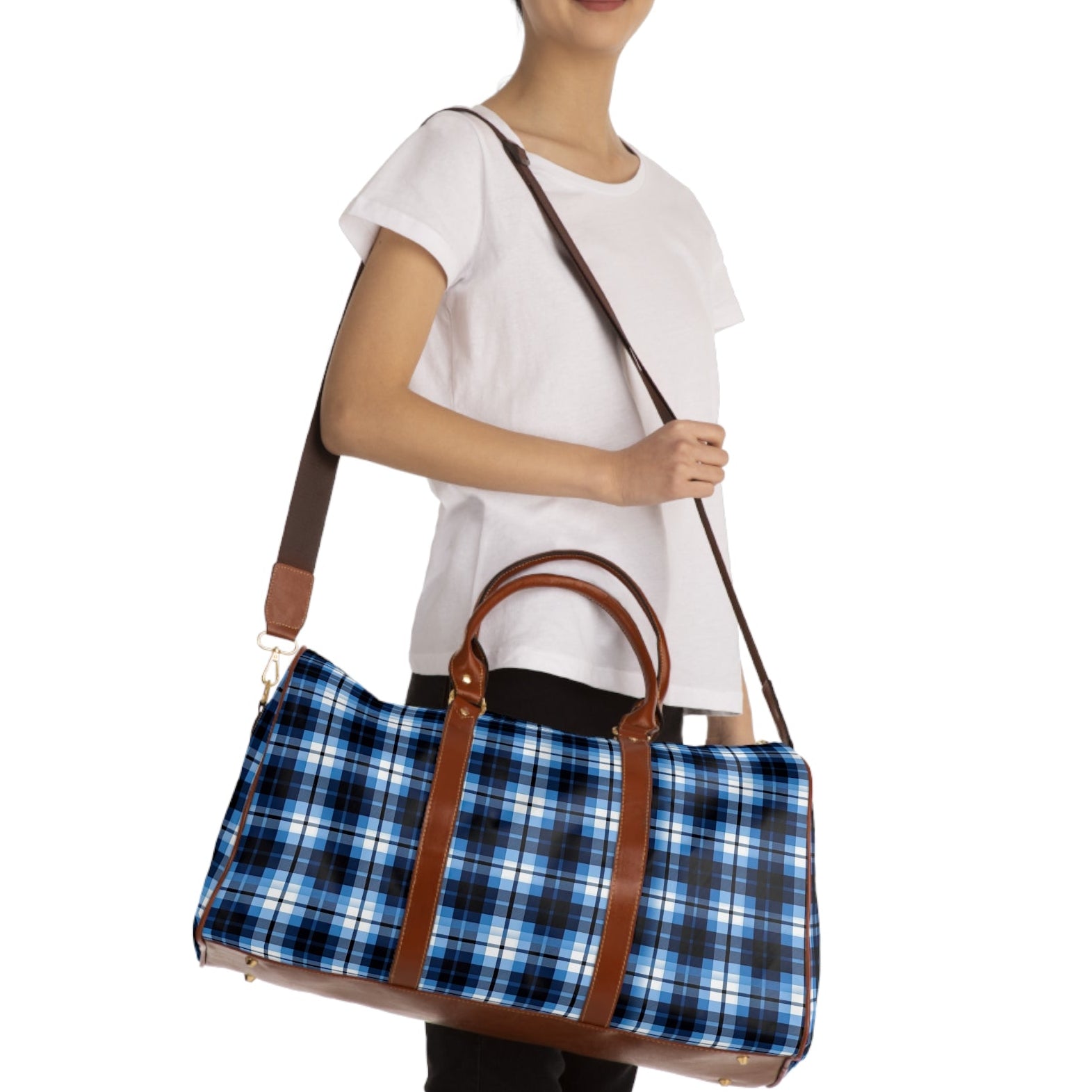 Woman holding a blue plaid bag with brown straps on a white background