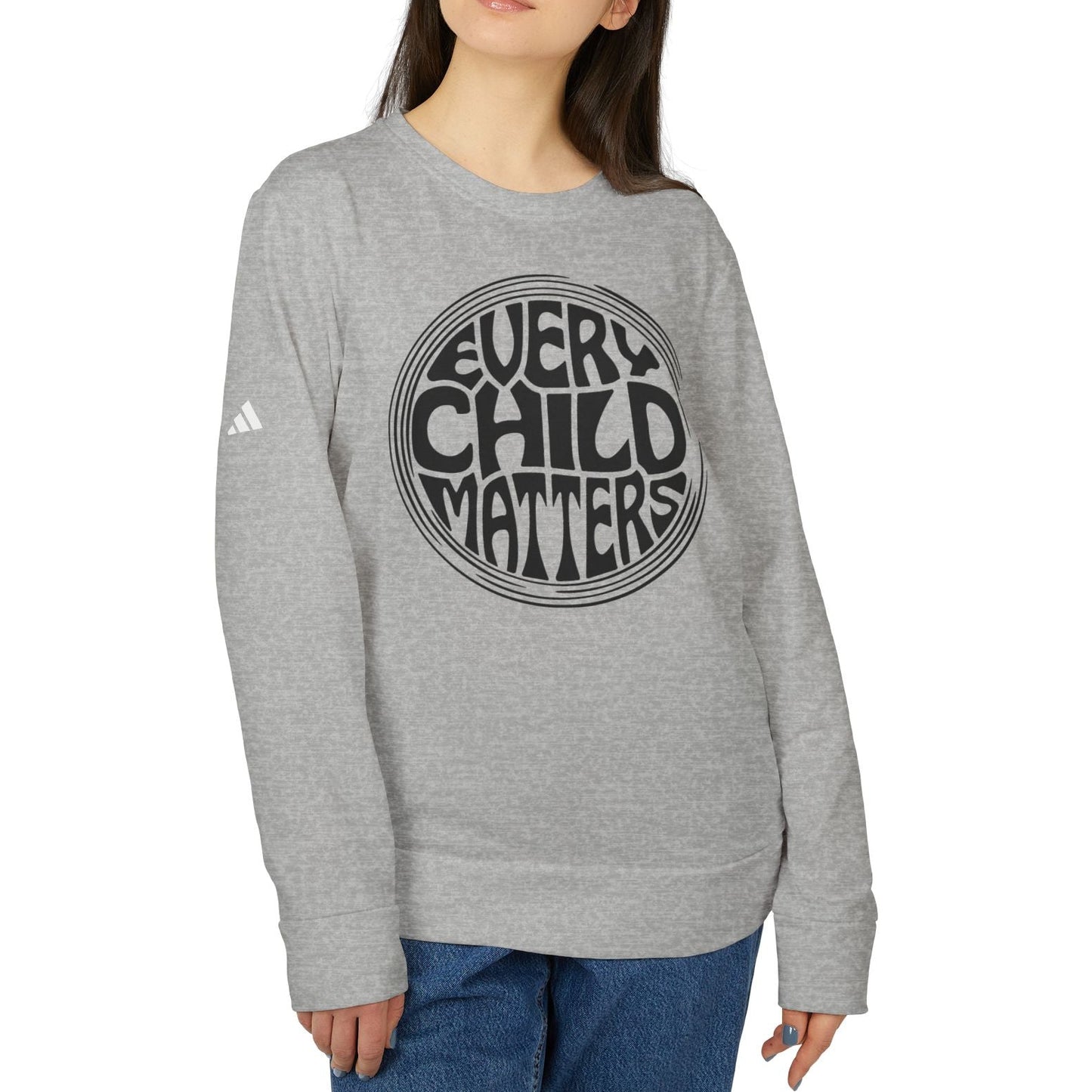 Person wearing a gray sweatshirt with 'Every Child Matters' text on a white background