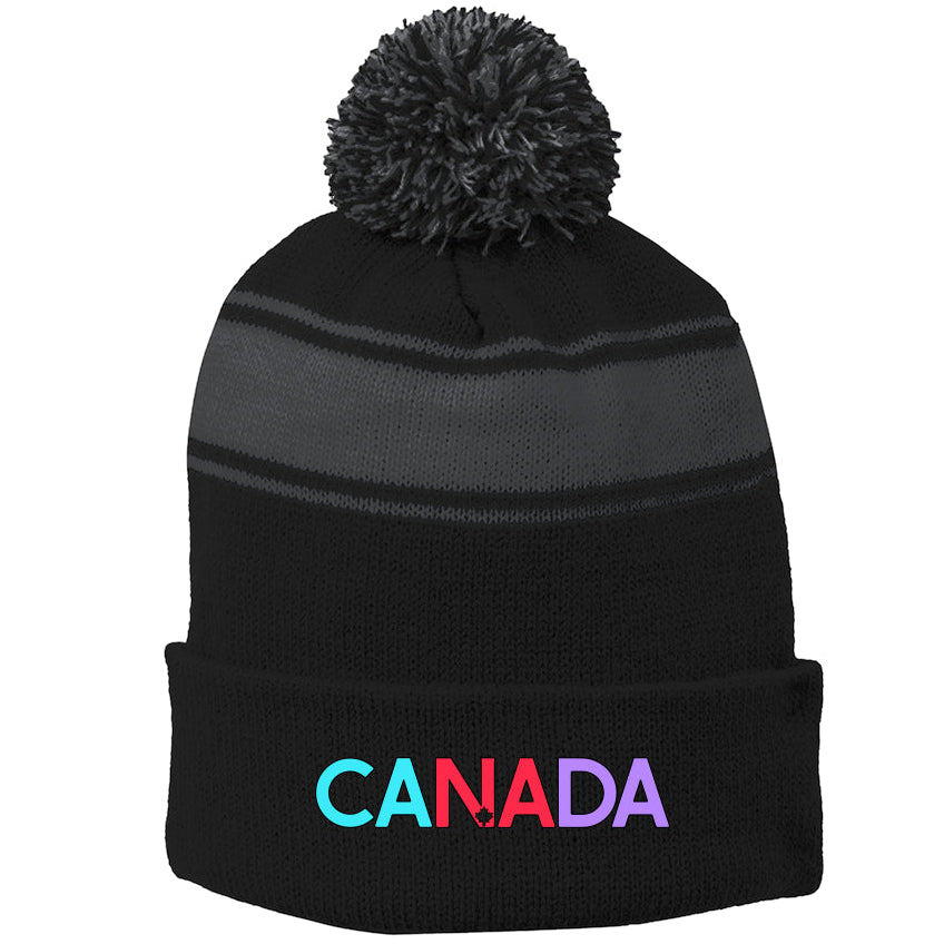 Black beanie with colorful 'CANADA' text and gray pom-pom on a white background