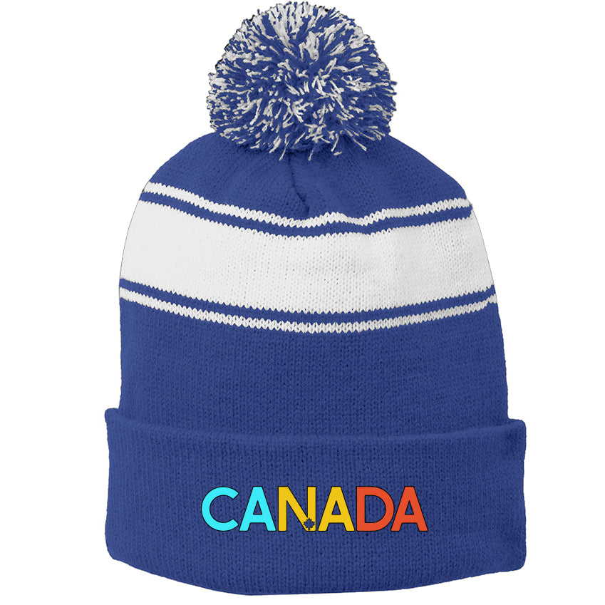 Blue and white beanie with a pom-pom and 'Canada' embroidered on a white background