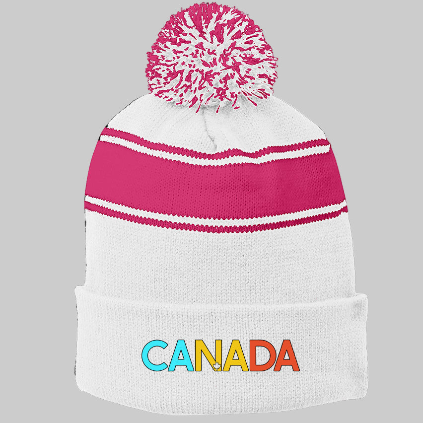 White knit beanie with pink top and colorful 'CANADA' text on a white background