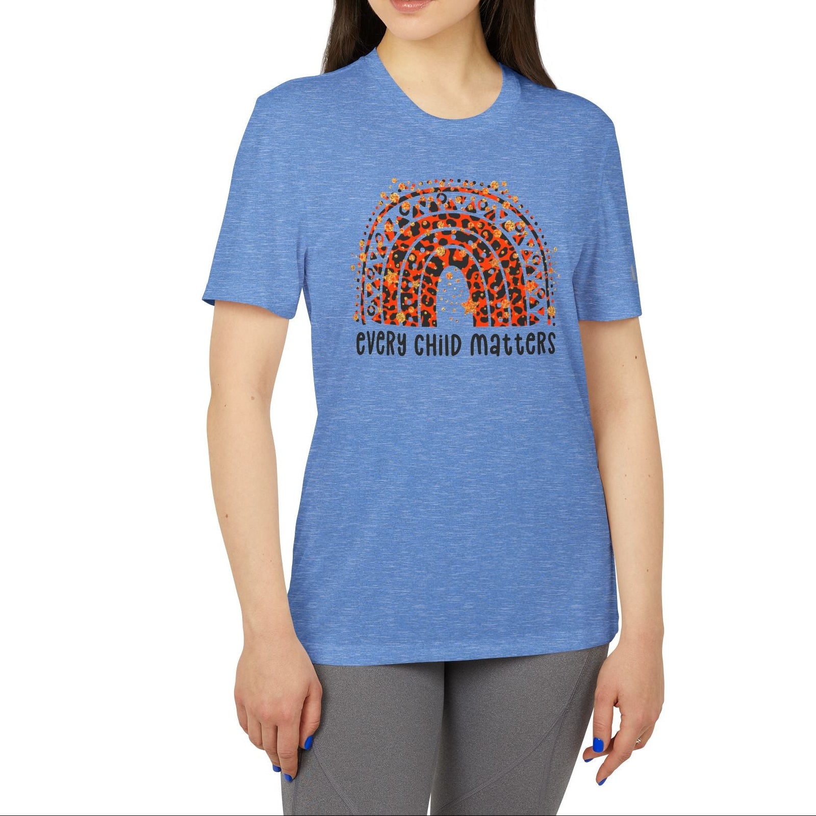 Woman wearing a blue t-shirt with a rainbow and text design on a white background