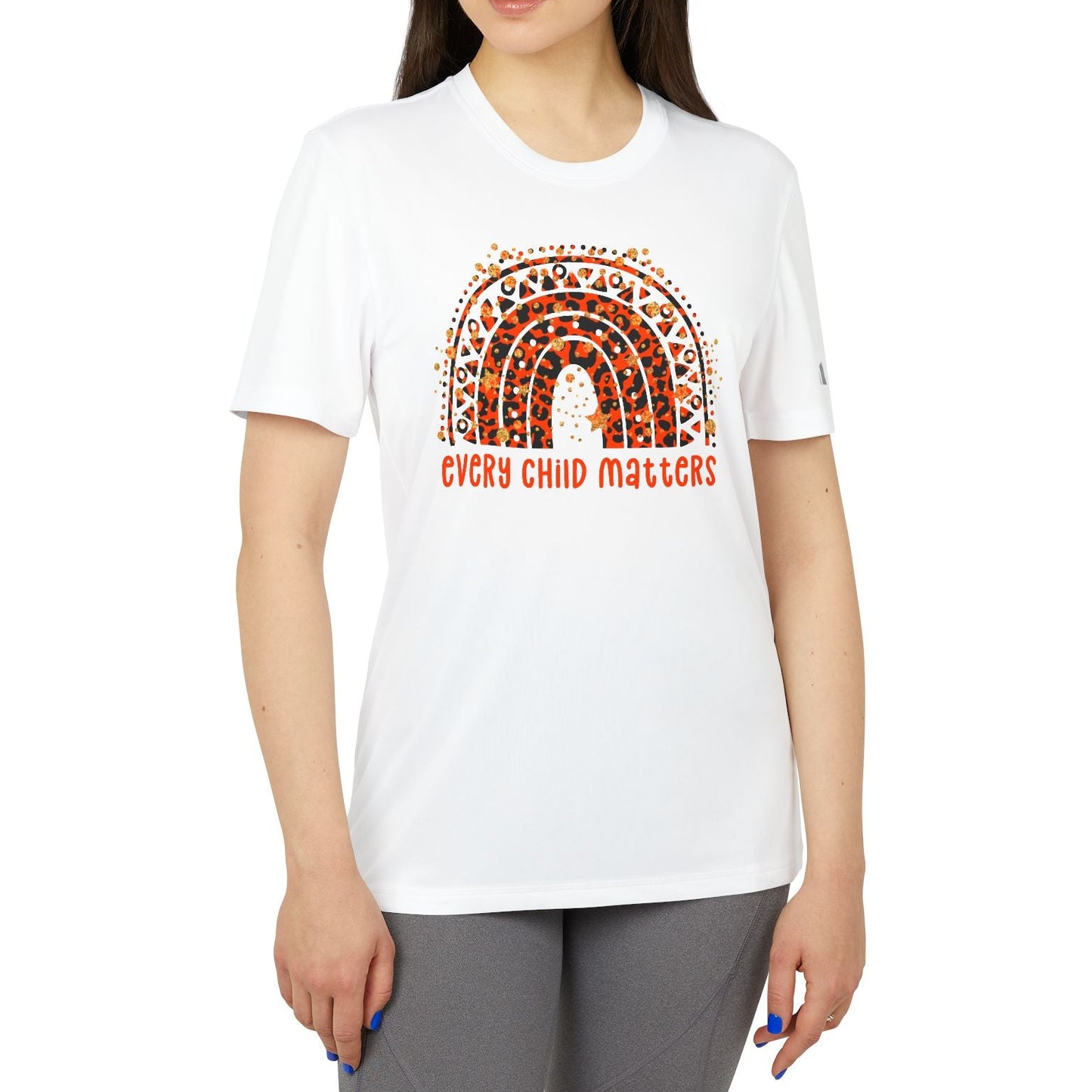 Woman wearing a white t-shirt with a rainbow design and 'Every Child Matters' text on a white background