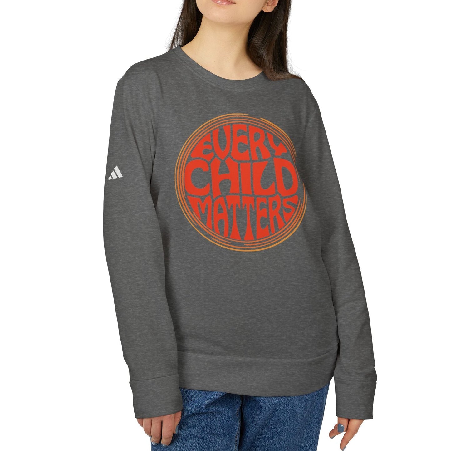 Person wearing a gray sweatshirt with 'Every Child Matters' text on a white background