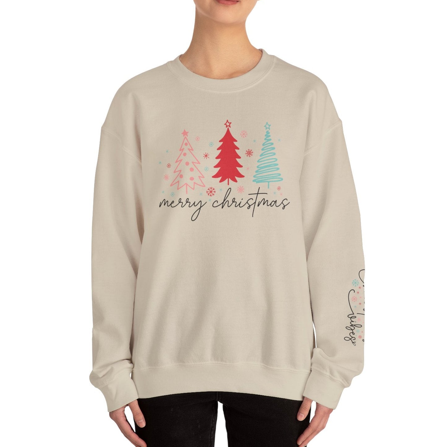Person wearing a beige sweatshirt with Christmas tree design and 'merry christmas' text on a white background