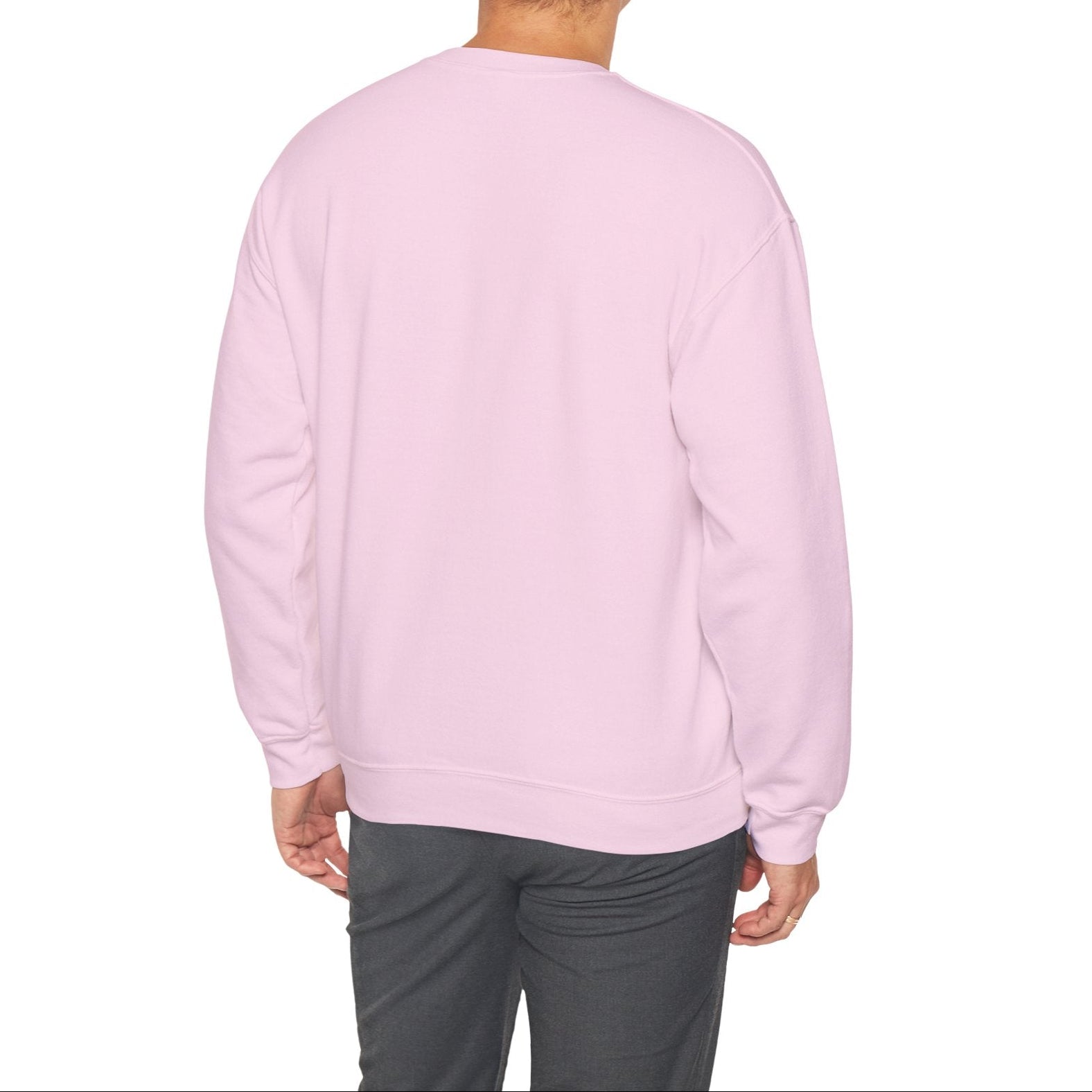 Person wearing a light pink sweatshirt on a white background