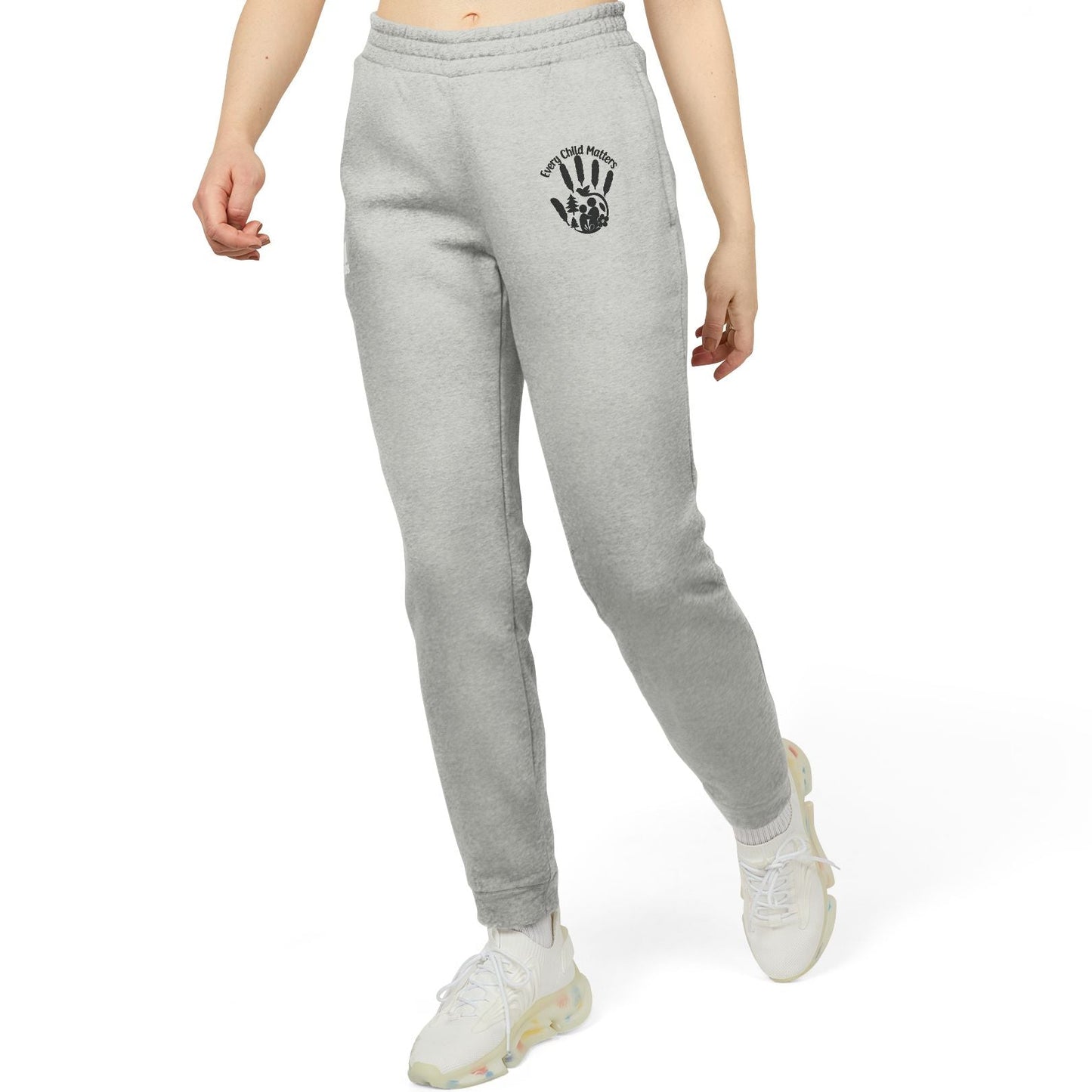 Person wearing gray sweatpants with a logo on a white background