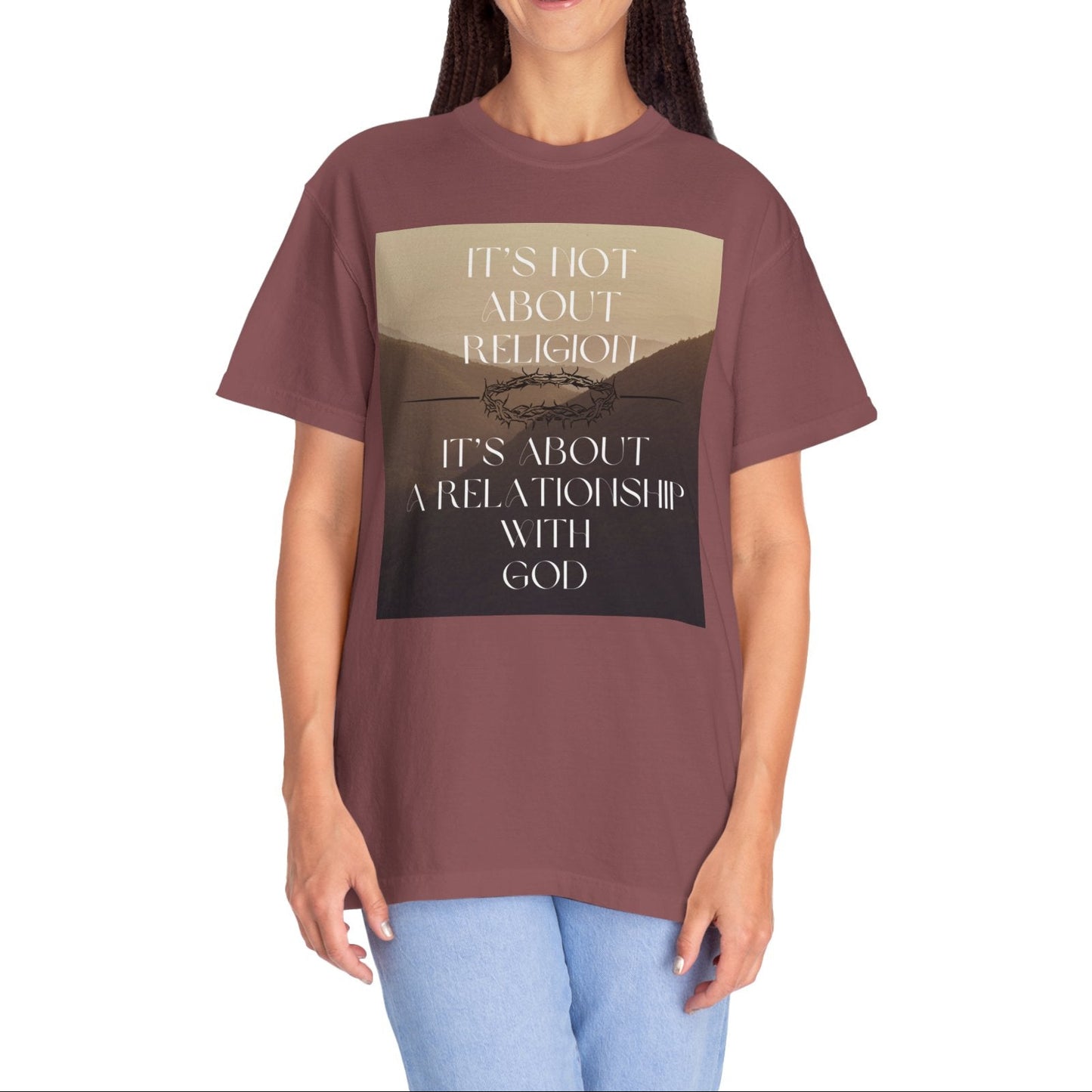 Person wearing a brown t-shirt with a graphic and text on a white background