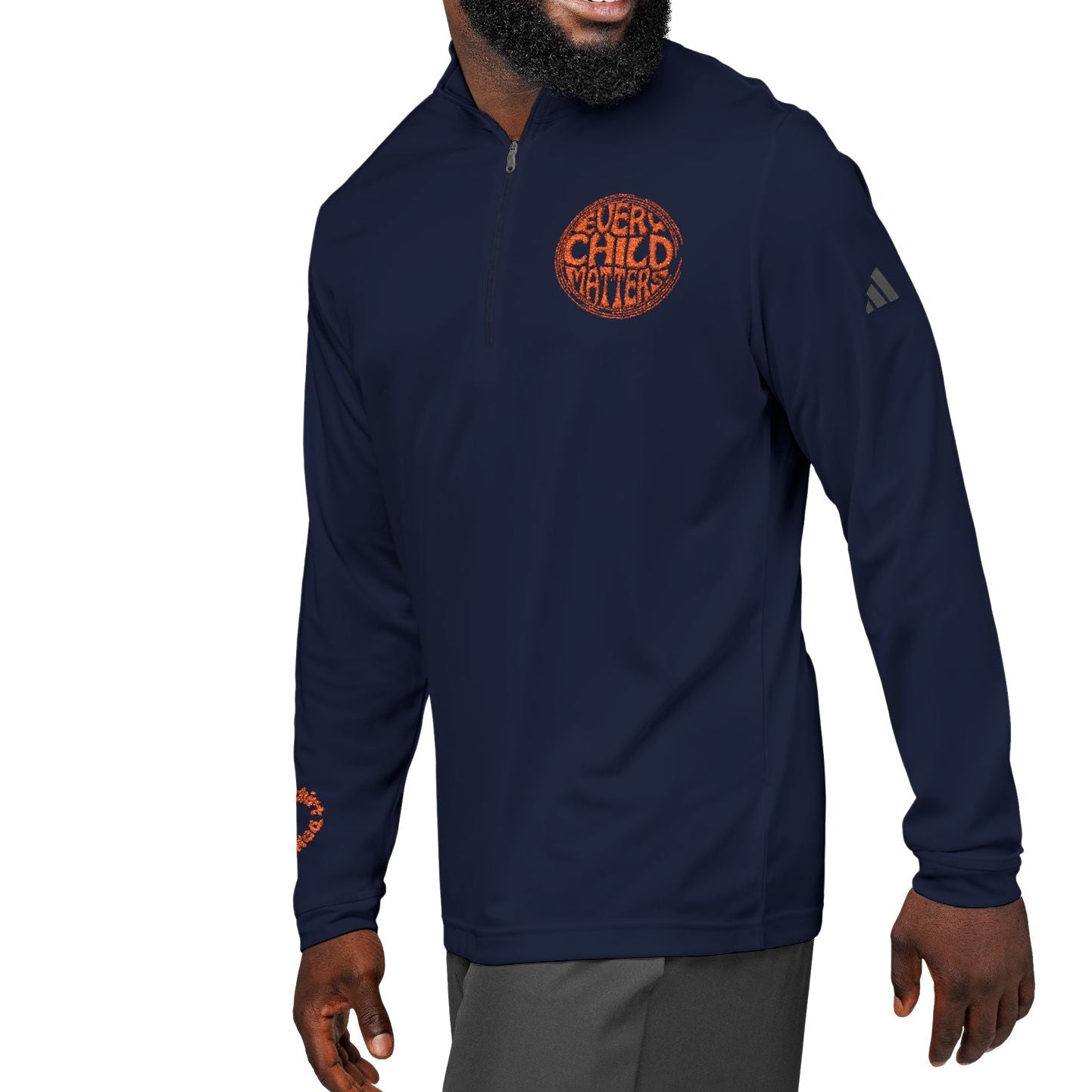 Man wearing a navy blue pullover with a logo on a white background