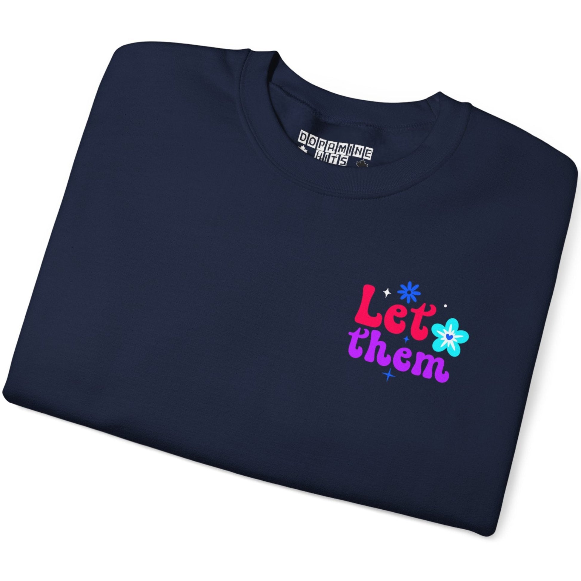 Folded navy blue sweatshirt with colorful text and graphics on a white background