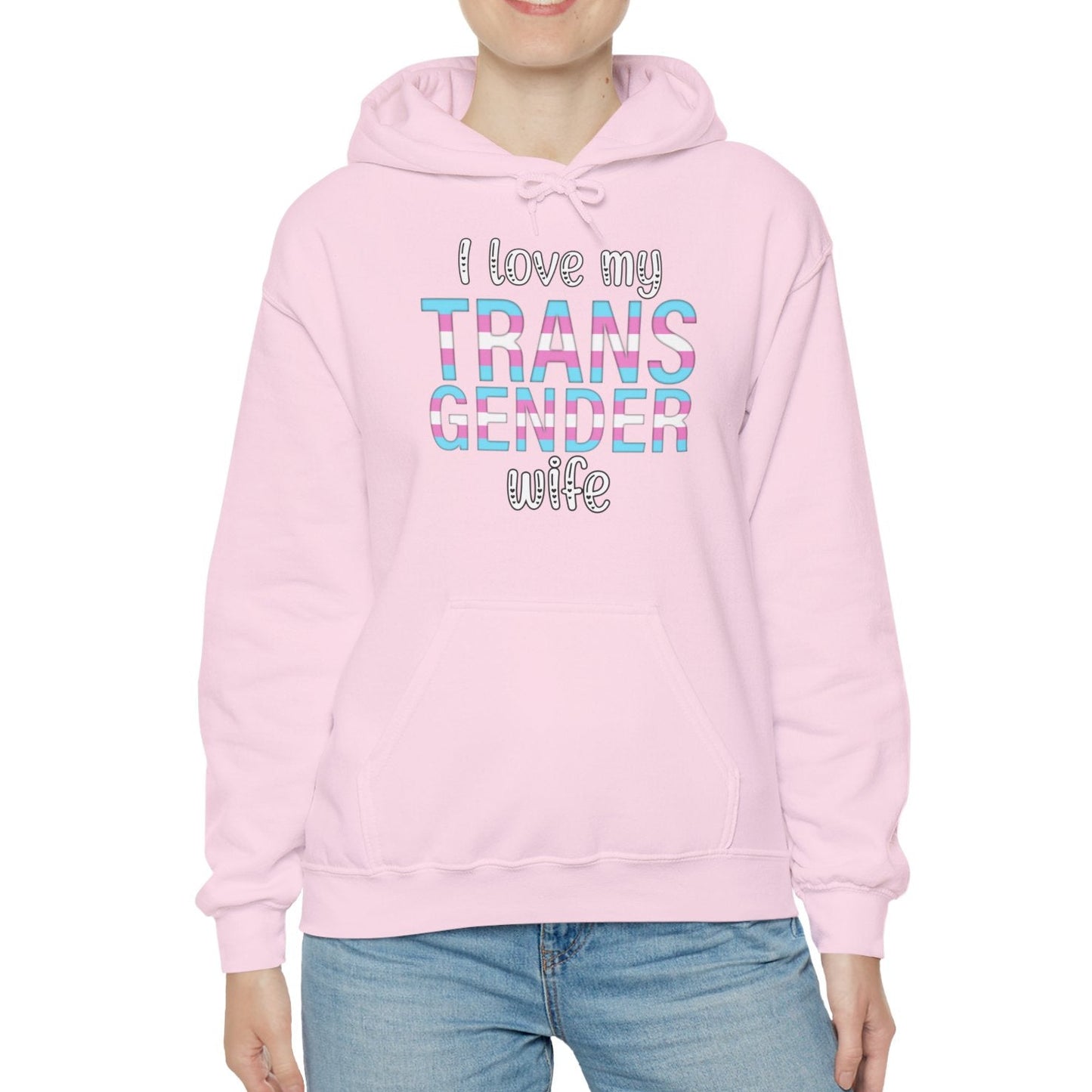 Person wearing a pink hoodie with text, standing against a white background