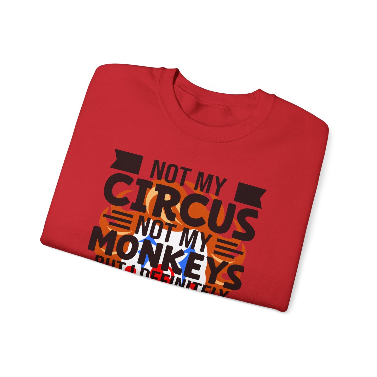 Folded red sweatshirt  with 'Not my circus, not my monkeys' text on a white background