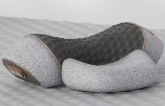 Gray and brown neck pillow on a textured surface