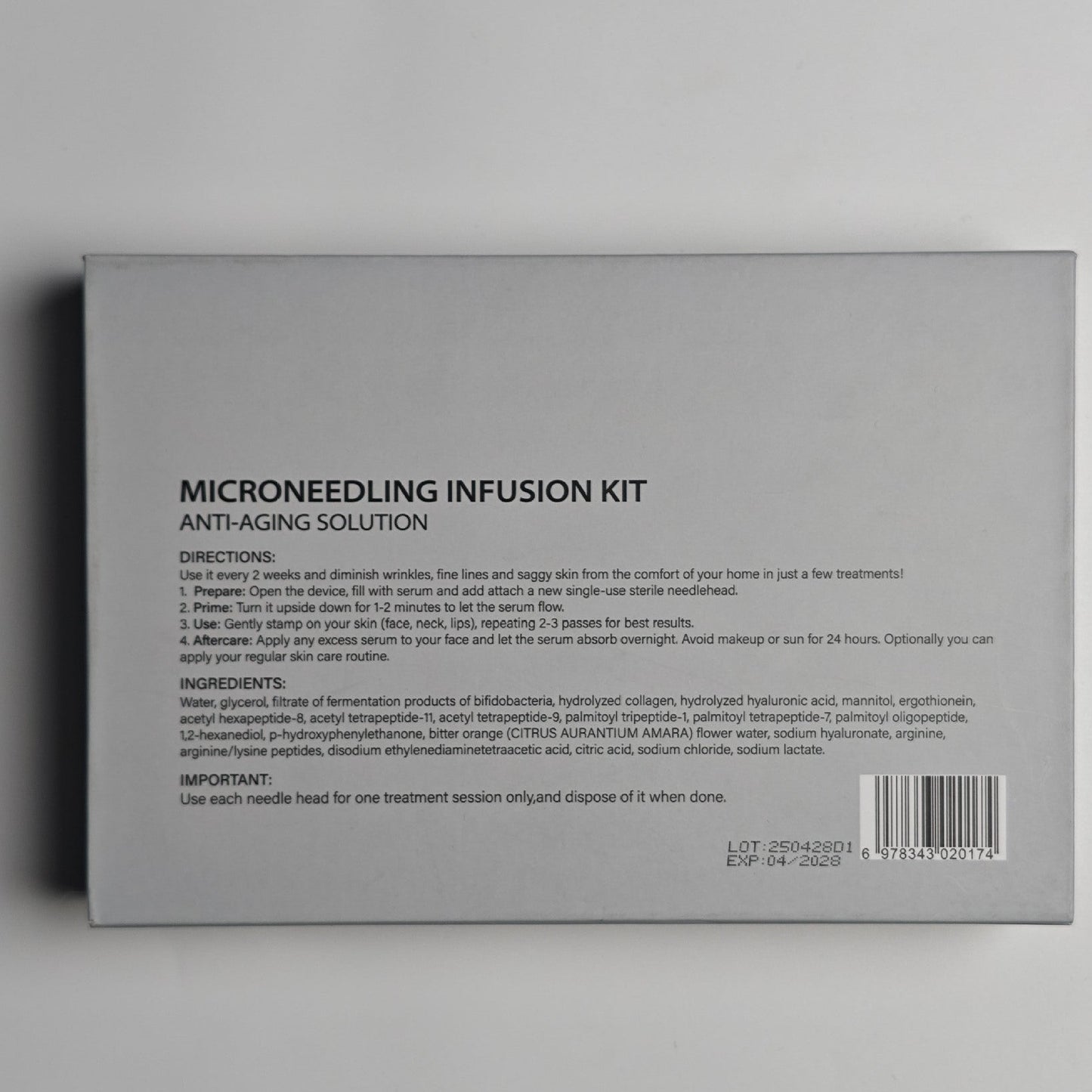 Back of a Microneedling Infusion Kit packaging with text and barcode on a gray background
