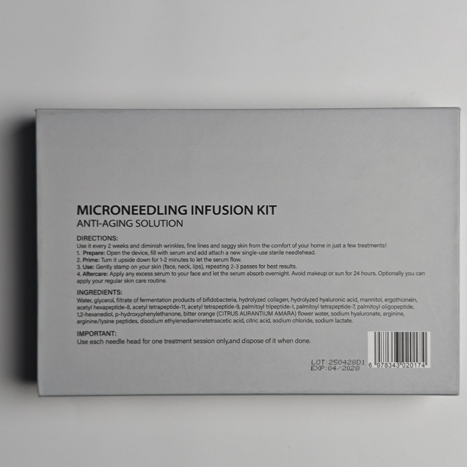 Back of a Microneedling Infusion Kit packaging with text and barcode on a gray background