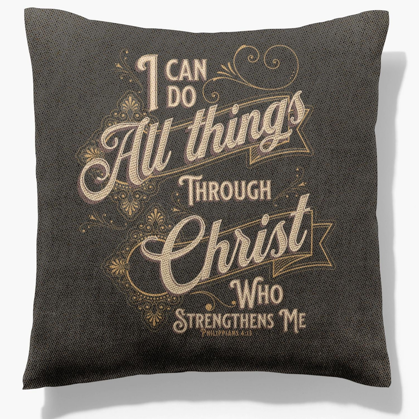 A square-shaped woven pillow with a dark background featuring text and a floral design.