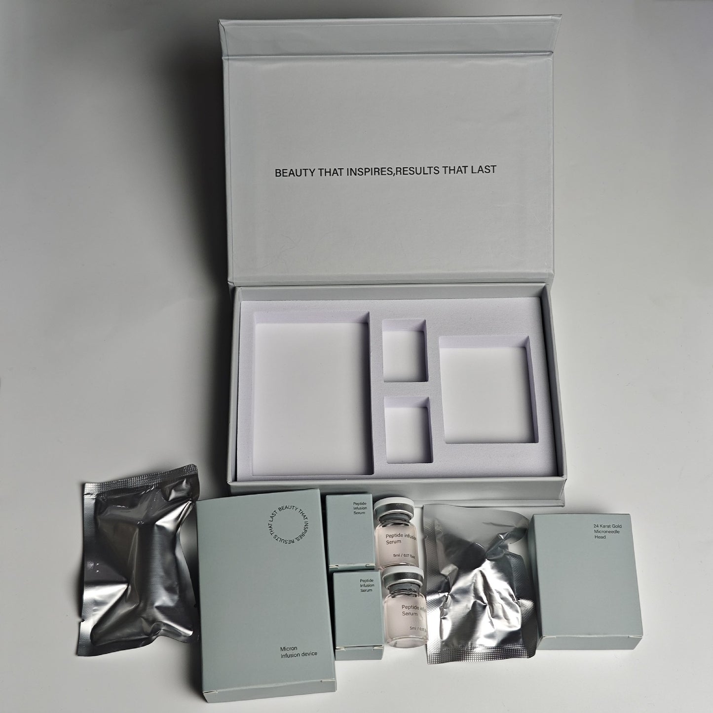 Cosmetic packaging set with various items on a gray background