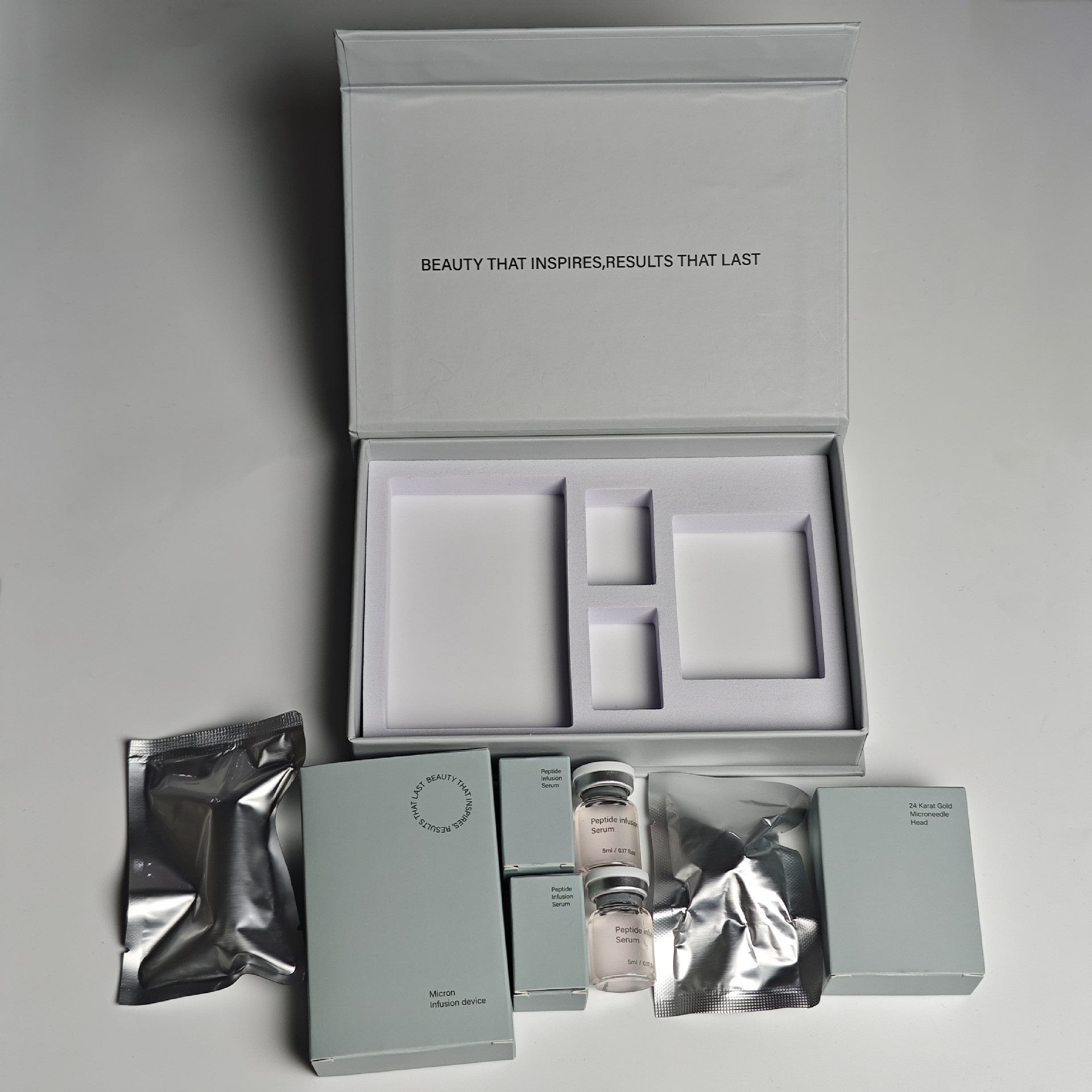Cosmetic packaging set with various items on a gray background