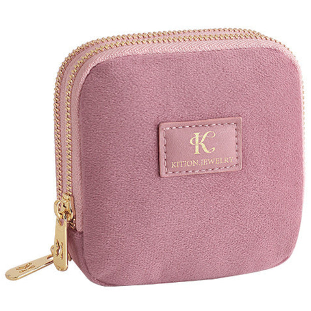 Pink jewelry case with gold zippers on a white background