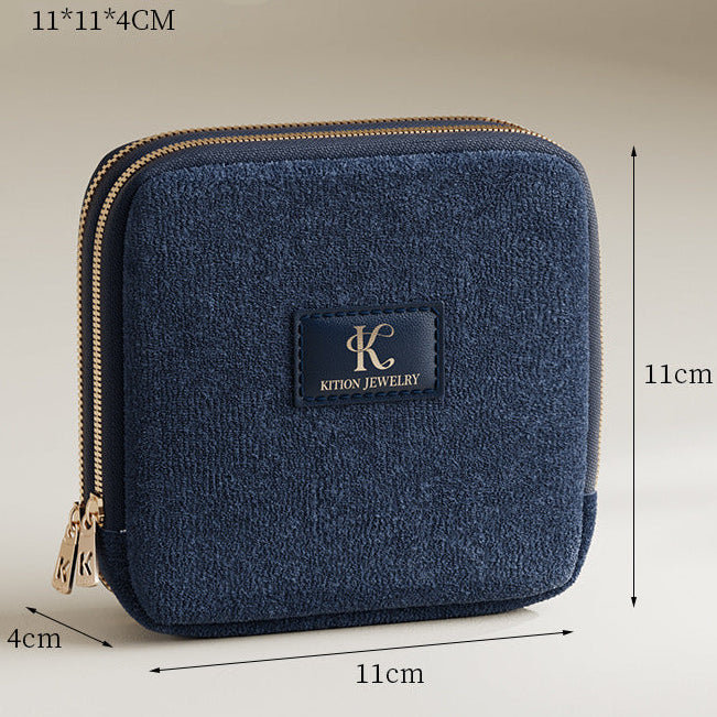 Blue jewelry case with dimensions on a beige background
