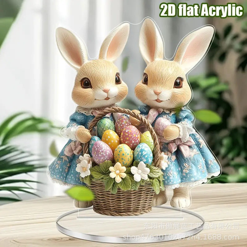 Two decorative bunny figurines with a basket of Easter eggs on a 2D flat acrylic stand.