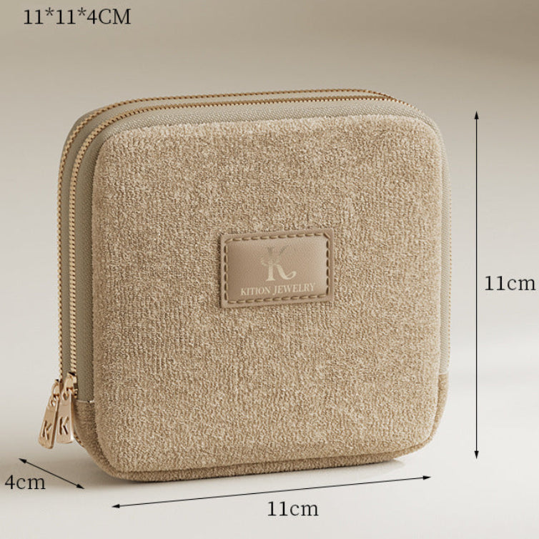 Beige jewelry pouch with dimensions on a beige background