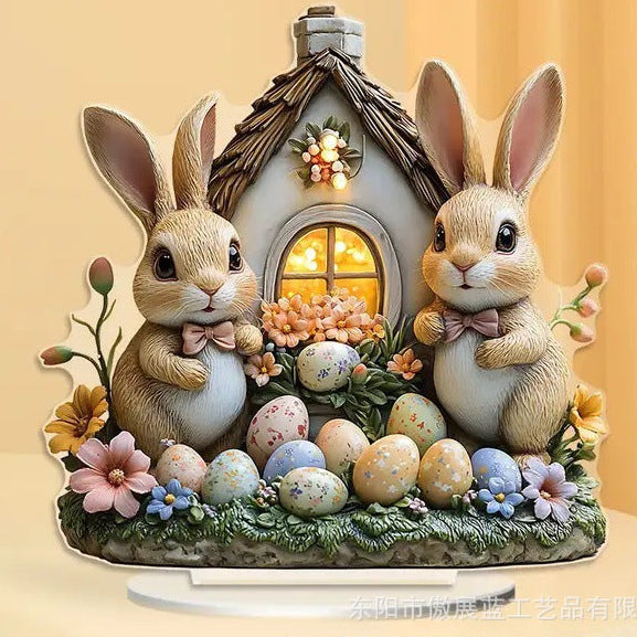 Decorative figurine of two rabbits with a small house and Easter eggs on a yellow background