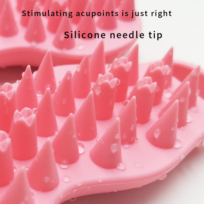 Pink silicone tool with needle-like projections on a white background