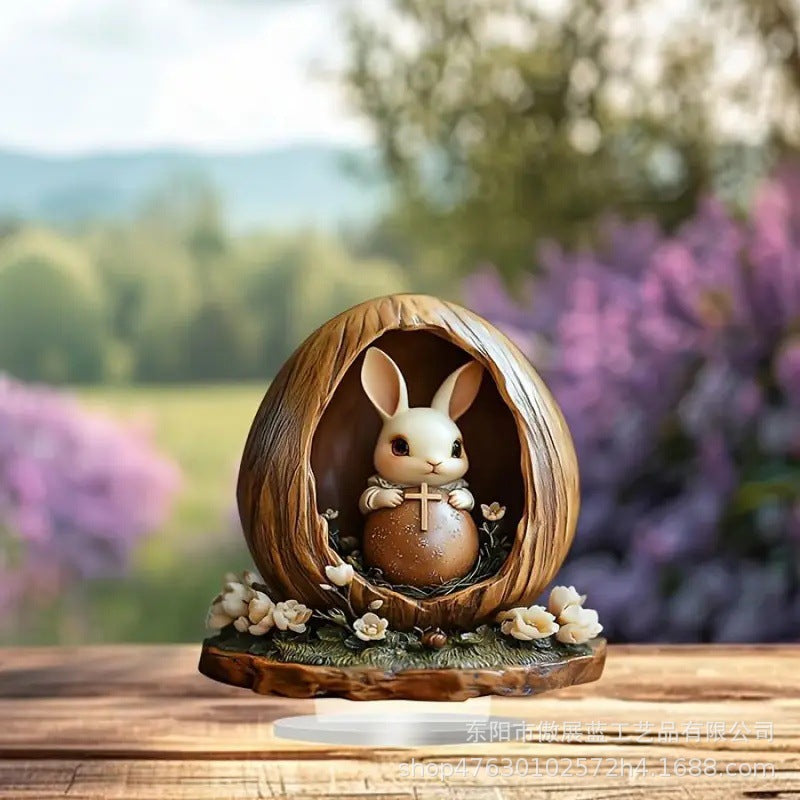 Decorative figurine of a rabbit with a tiny cross in an egg with a blurred outdoor background