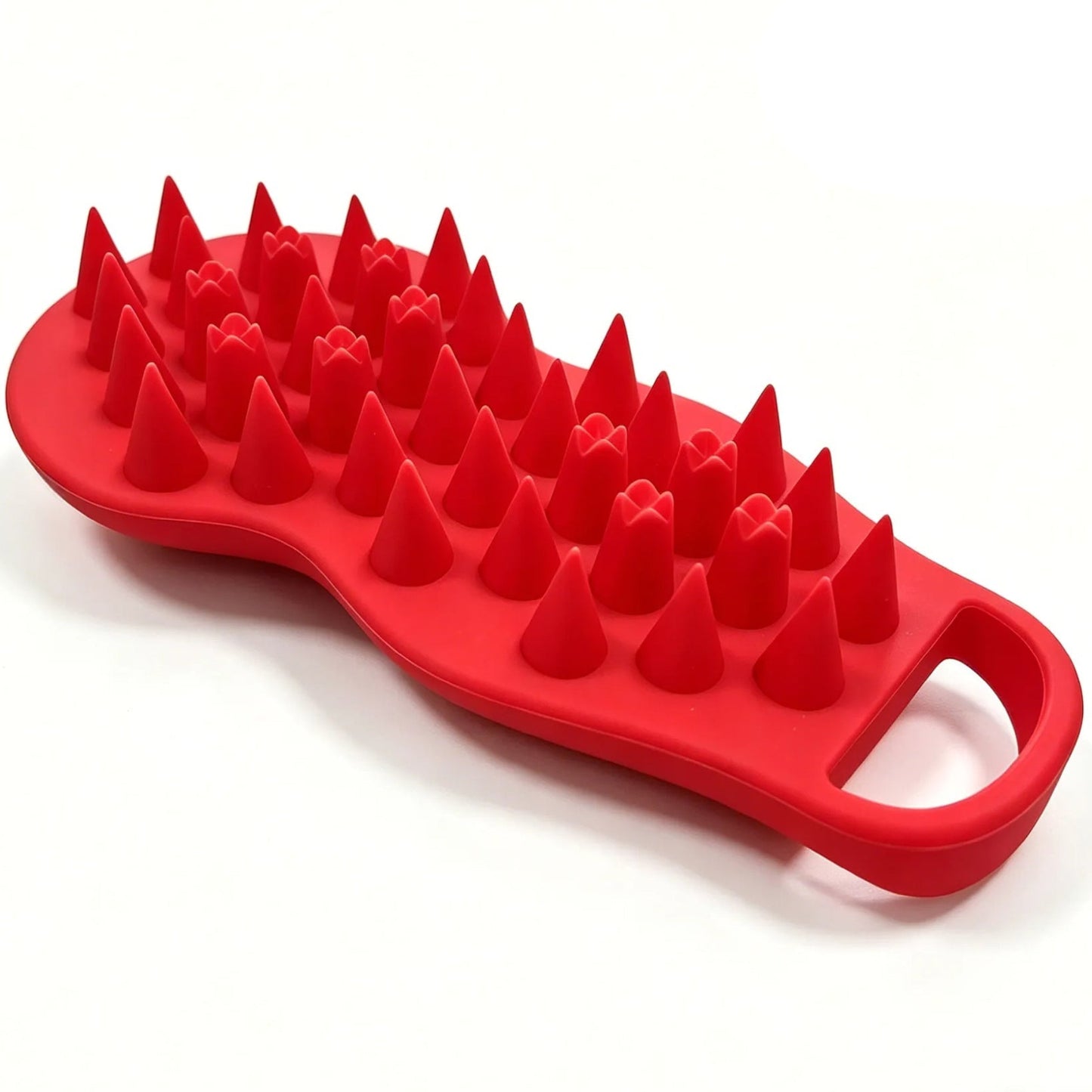 Red silicone scrubber with textured surface on a white background