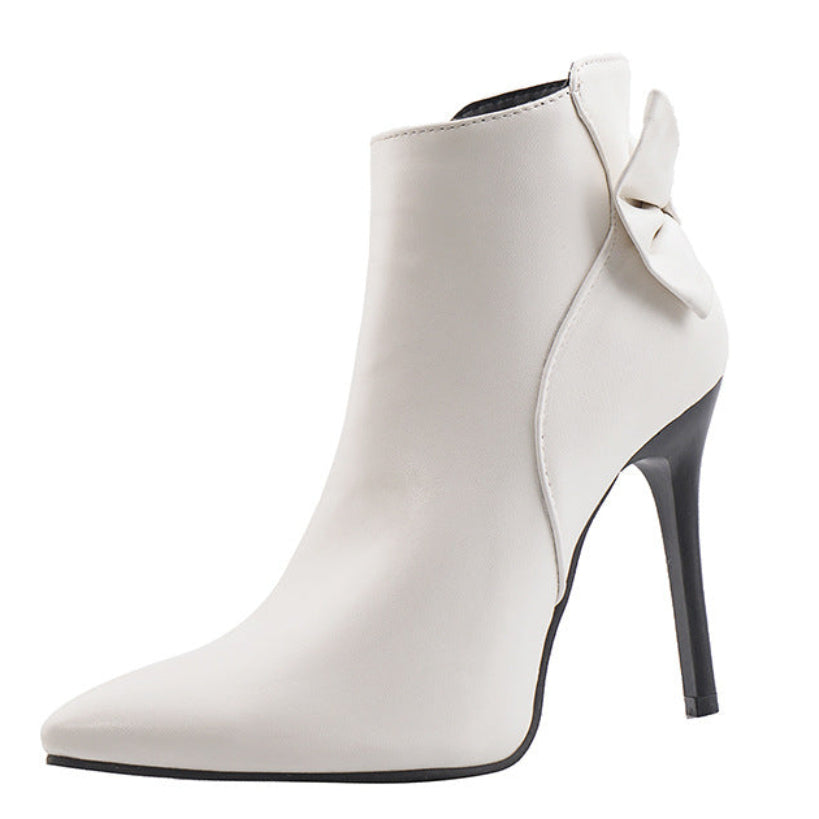 White ankle boot with a pointed toe and high heel on a white background