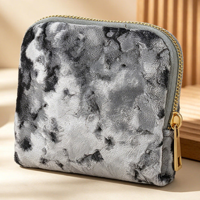 Gray Marble-textured pouch with gold zipper on a beige surface