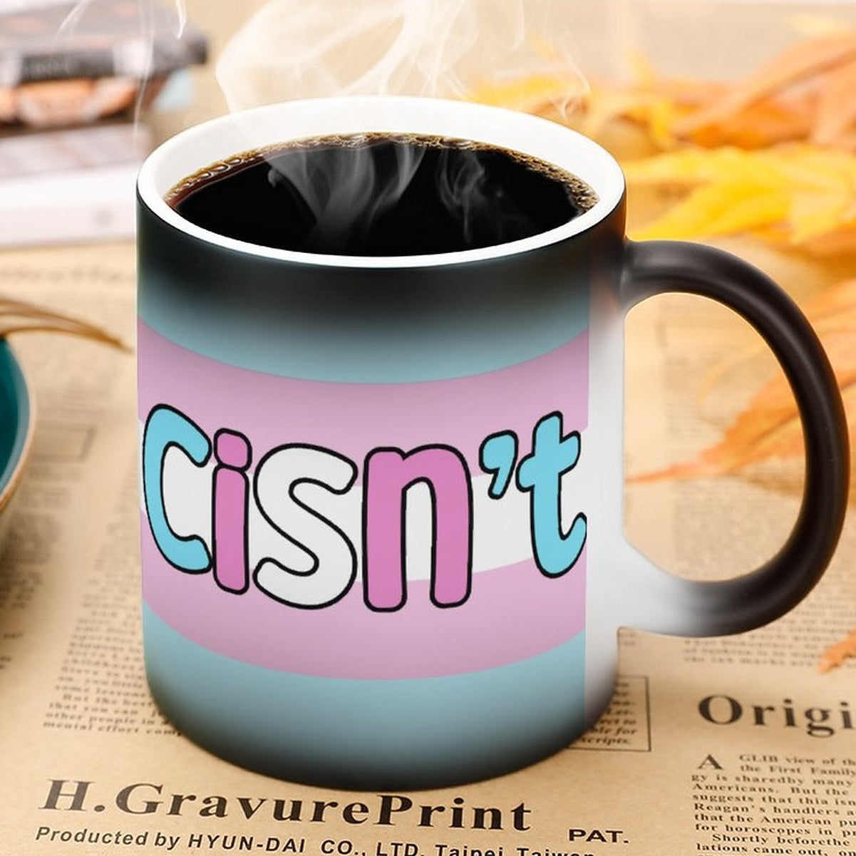 Mug with 'cisn't' text on a newspaper background