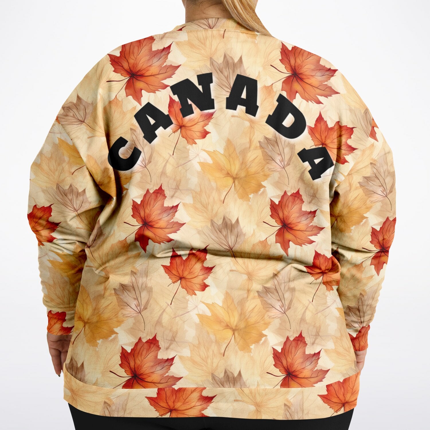 sweatshirt with autumn leaf pattern and 'CANADA' text on a plain background