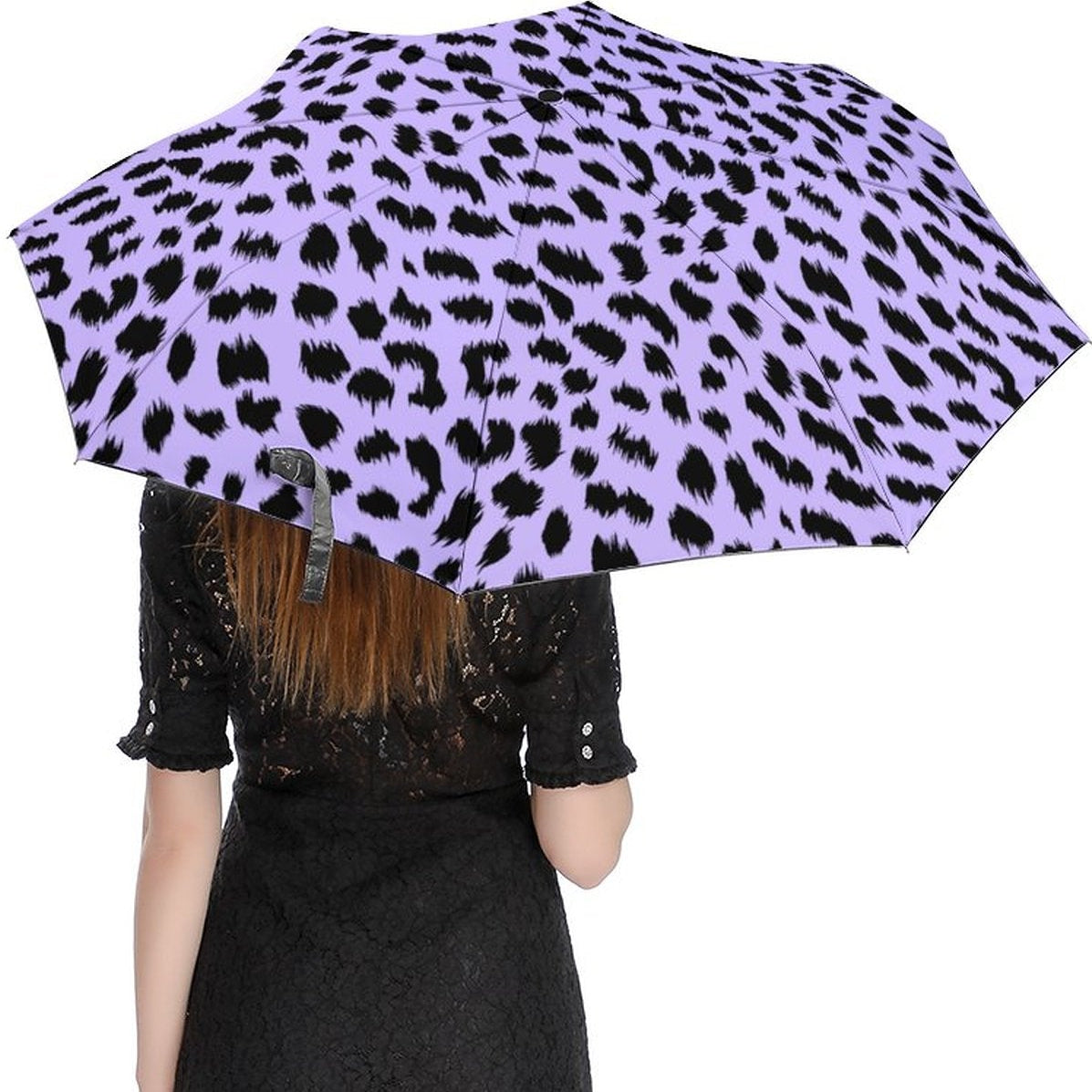 Person holding a purple umbrella with black leopard print pattern on a white background