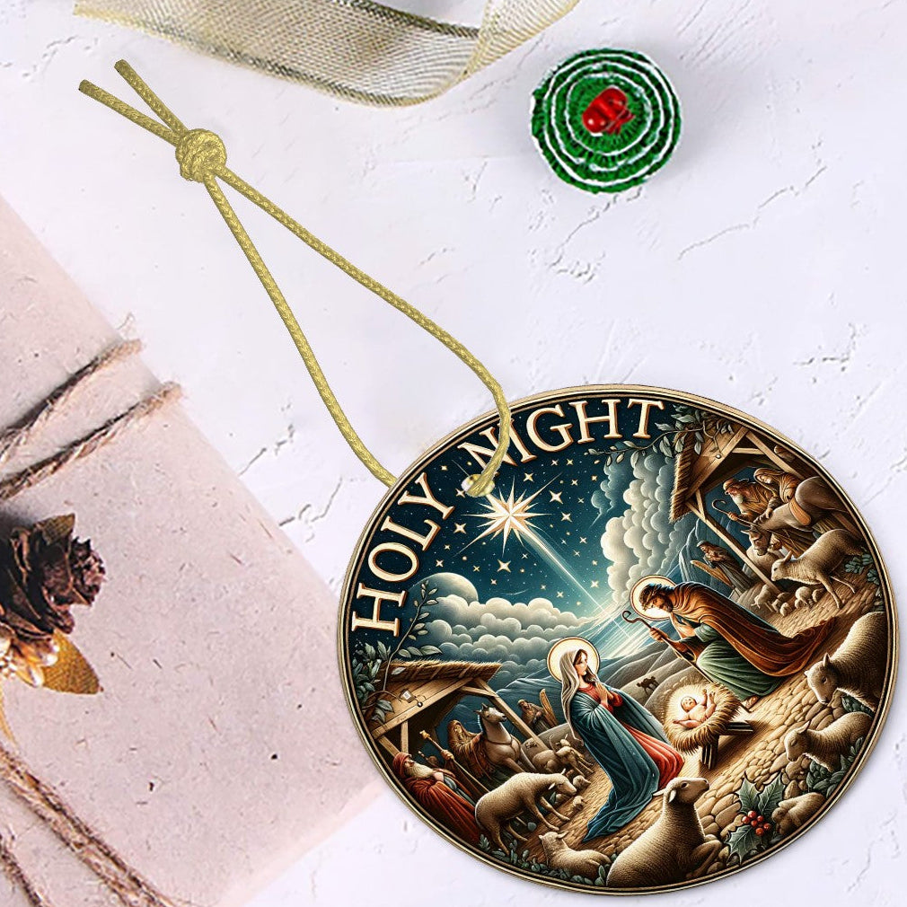 Decorative Christmas ornament with nativity scene design on a white surface.