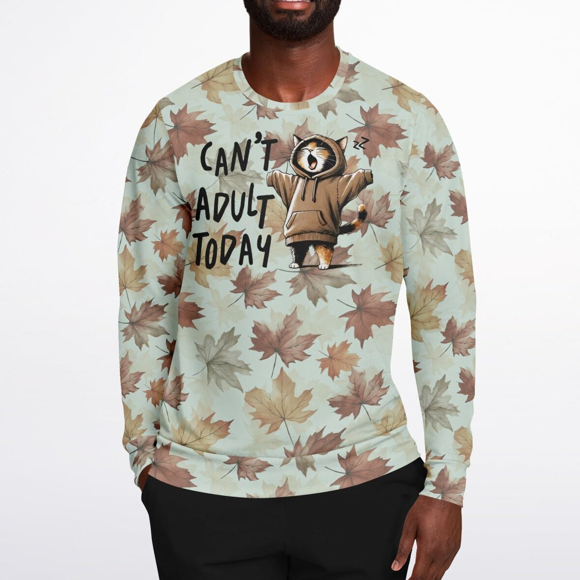 Person wearing a sweater with a cat graphic and text on a light background