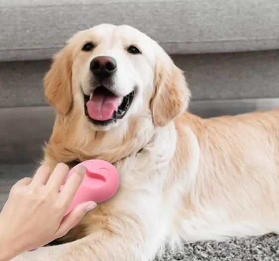 Happy Golden Retriever lying the floor with a pink pet product.